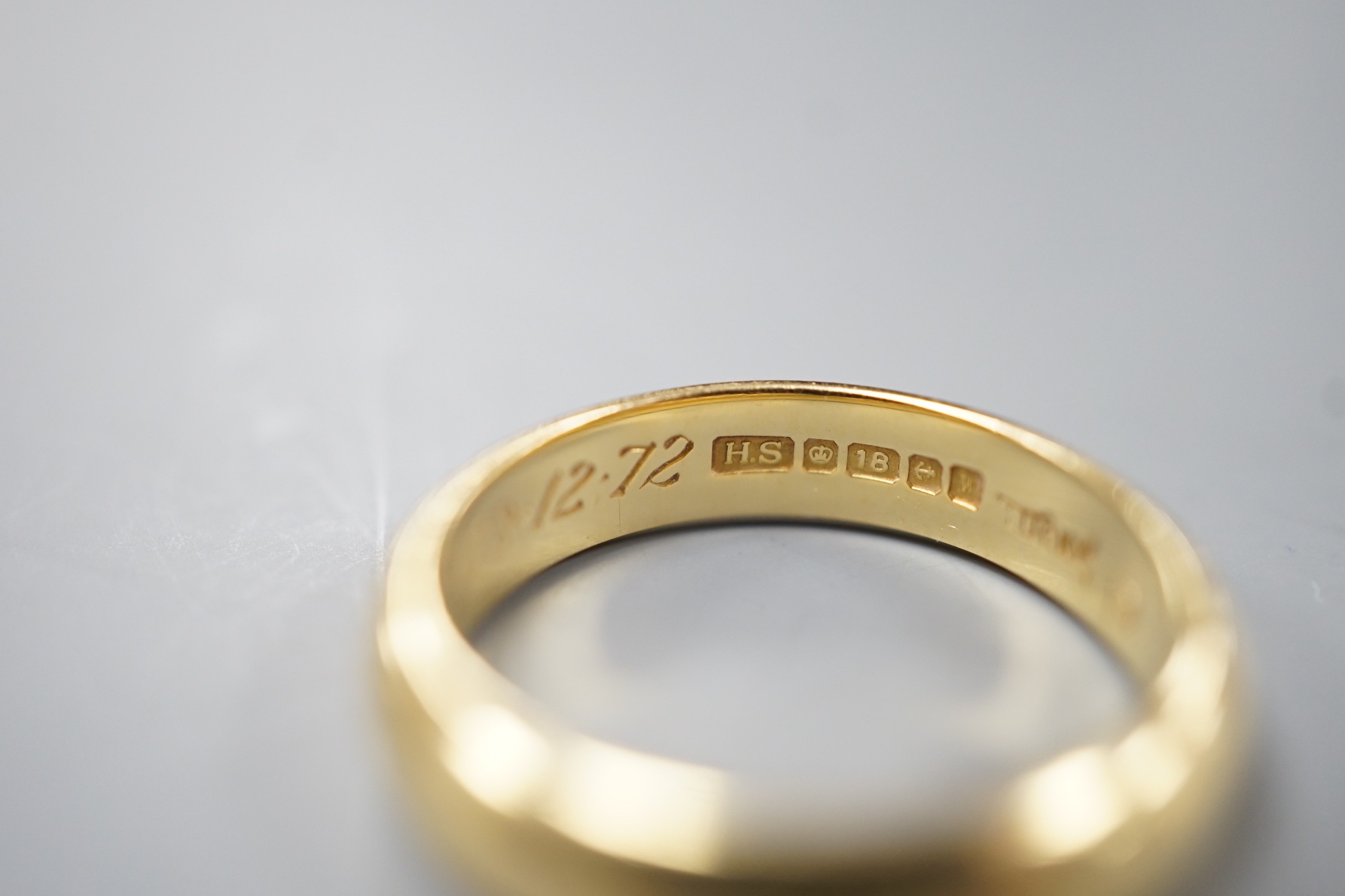 A 1970's 18ct gold wedding band, with engraved inscription, size O/P, 6.7 grams.